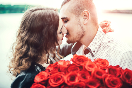 Pretty couple  in the park near lakeの写真素材