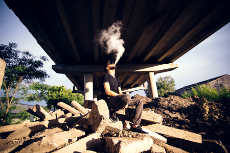 Men with beard vaping outdoor in sunglassesの写真素材