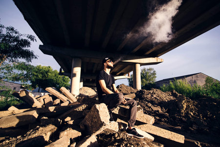 Men with beard vaping outdoor in sunglassesの写真素材