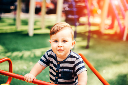 Pretty little baby playing outdoor in the parkの写真素材