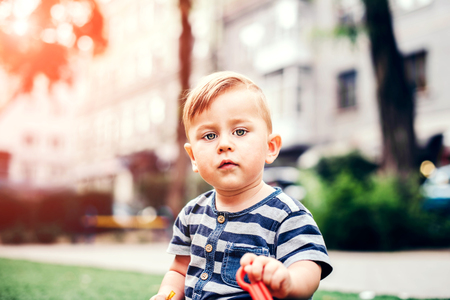 Pretty little baby playing outdoor in the parkの写真素材