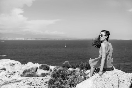 Young brunette girl relaxing near outdoor near seaの写真素材