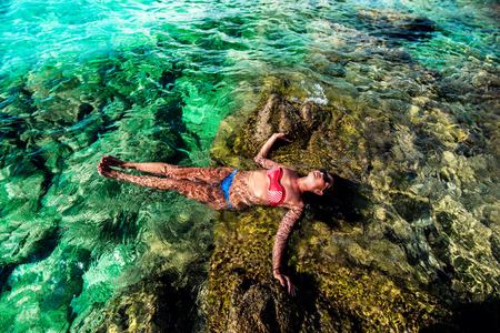 Pretty brunette girl relaxing in the waterの写真素材