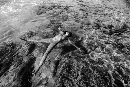 Pretty brunette girl relaxing in the waterの写真素材