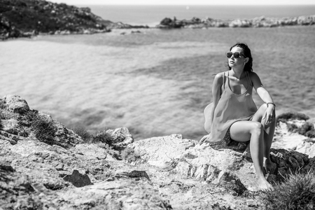Young brunette girl relaxing near outdoor near seaの写真素材