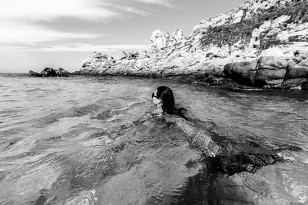 Pretty brunette girl relaxing in the waterの写真素材