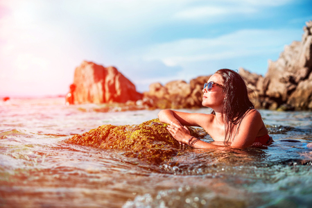 Pretty brunette girl relaxing in the waterの写真素材