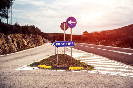 Conceptual road sign with new life motivationの写真素材