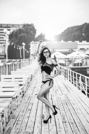 Pretty girl in black swimsuit relaxing outdoorの写真素材