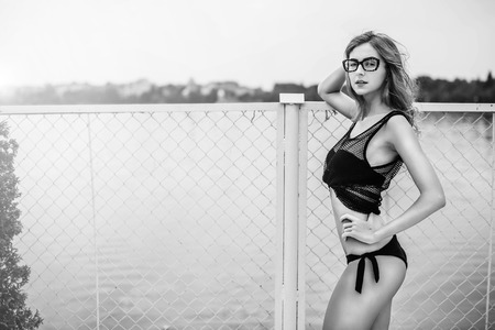 Pretty girl in black swimsuit relaxing outdoorの写真素材
