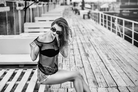 Pretty girl in black swimsuit relaxing outdoorの写真素材