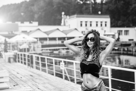 Pretty girl in black swimsuit relaxing outdoorの写真素材