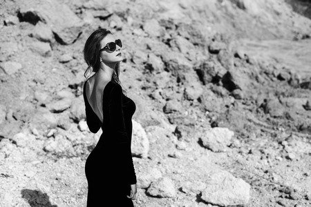 Woman in long black dress walking outdoorの写真素材