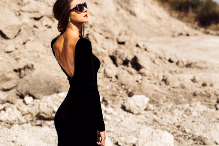 Woman in long black dress walking outdoorの写真素材