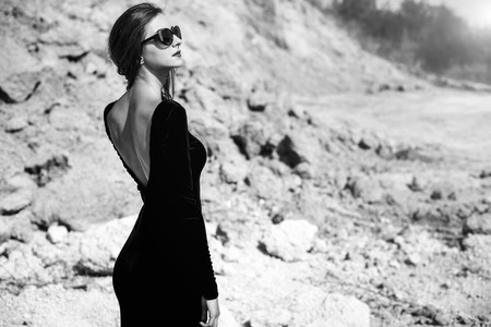 Woman in long black dress walking outdoorの写真素材
