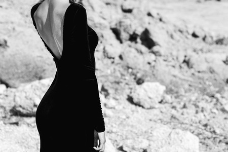 Woman in long black dress walking outdoorの写真素材