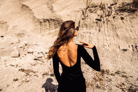 Woman in long black dress walking outdoorの写真素材