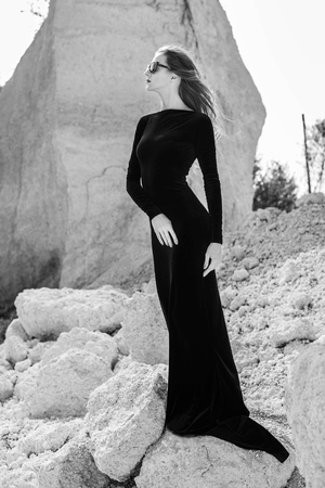 Woman in long black dress walking outdoorの写真素材