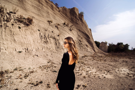 Woman in long black dress walking outdoorの写真素材