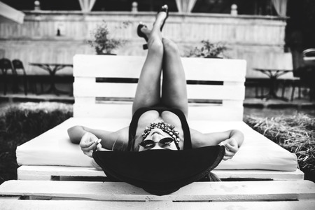 Young pretty sexy girl relaxing outdoor in black swimwearの写真素材