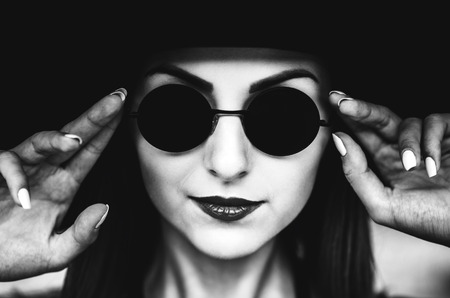 Portrait of pretty young women outdoor in black hatの写真素材