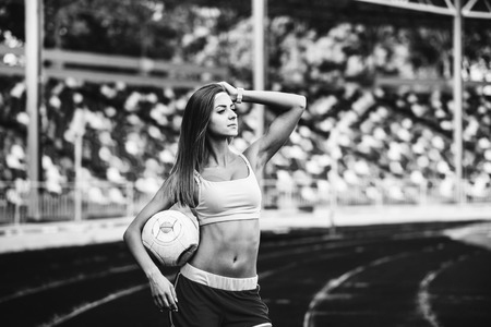Girl workout on stadium in blue shortsの写真素材