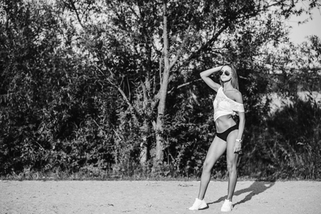 Sporty girl walking on the beach in swimwearの写真素材