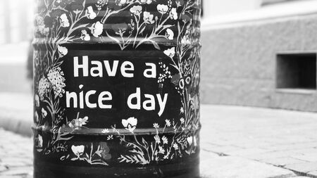 Friendly metal barrel on the street outdoor with "have a nice day" printの写真素材