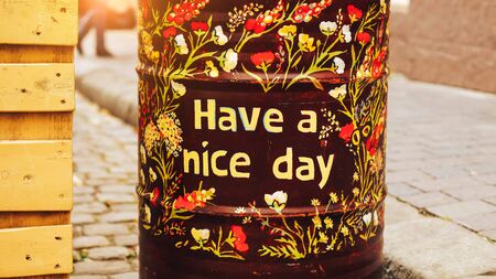Friendly metal barrel on the street outdoor with "have a nice day" printの写真素材