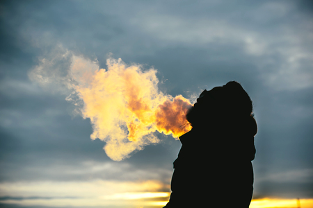Man with beard smoke electronic cigarette outdoorの写真素材