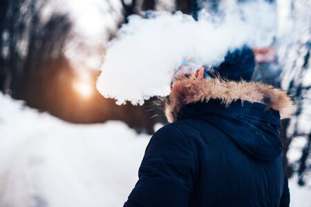 Man with beard smoke electronic cigarette outdoorの写真素材