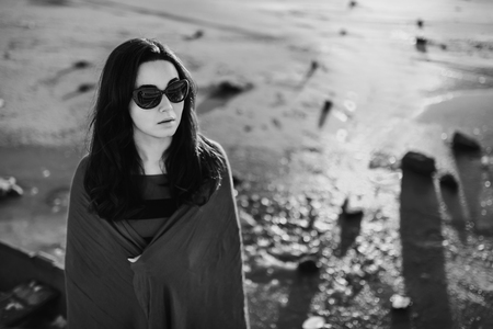 Pretty brunette girl standing outdoor in the old boatの写真素材