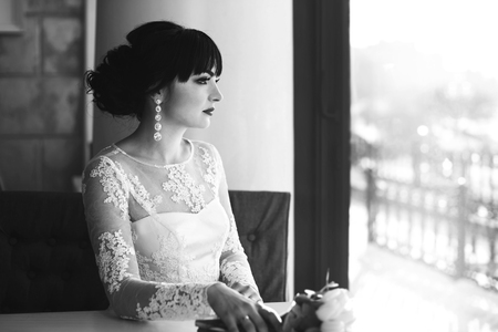 Pretty young bride sitting in the cafeの写真素材