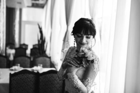 Happy young bride with wedding bouquetの写真素材