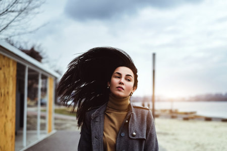 Young brunette woman walking outdoor in the park