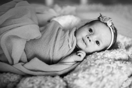 cute newborn baby girl in the bedの写真素材
