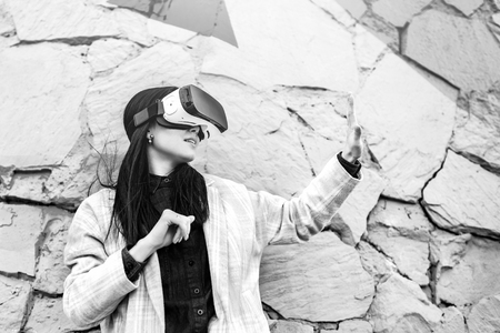 Brunette girl outdoor in VR glasses, black and whiteの写真素材