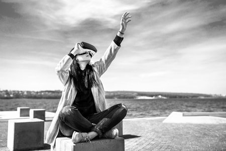 Brunette girl outdoor in VR glasses, black and whiteの写真素材