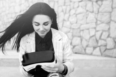 Brunette girl outdoor in VR glasses, black and whiteの写真素材