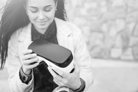 Brunette girl outdoor in VR glasses, black and whiteの写真素材