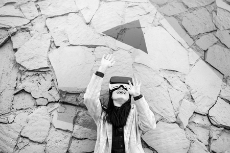 Brunette girl outdoor in VR glasses, black and whiteの写真素材