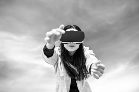 Brunette girl outdoor in VR glasses, black and whiteの写真素材
