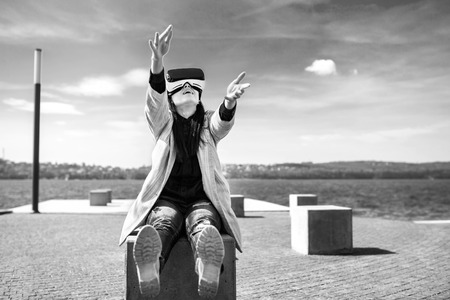 Brunette girl outdoor in VR glasses, black and whiteの写真素材