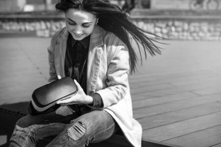 Brunette girl outdoor in VR glasses, black and whiteの写真素材