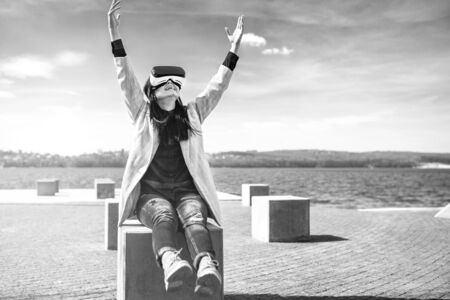 Brunette girl outdoor in VR glasses, black and whiteの写真素材