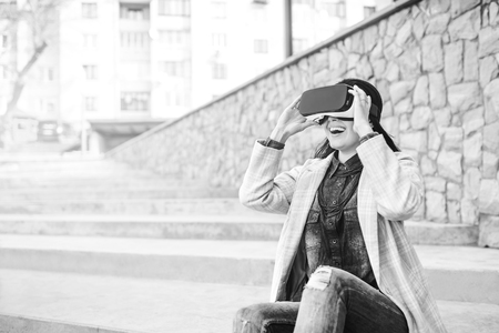 Brunette girl outdoor in VR glasses, black and whiteの写真素材