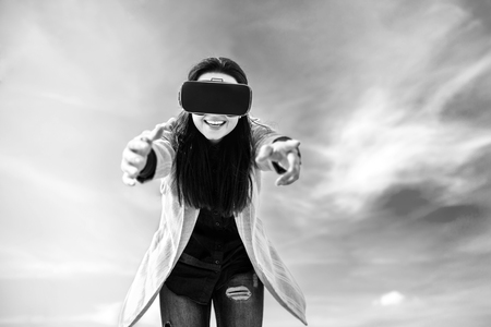 Brunette girl outdoor in VR glasses, black and whiteの写真素材