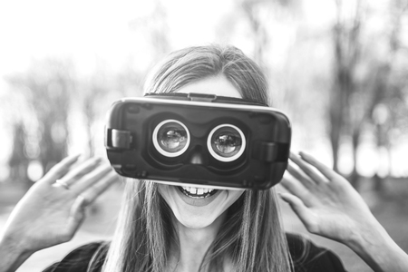 Pretty girl enjoy virtual reality glasses, black and whiteの写真素材