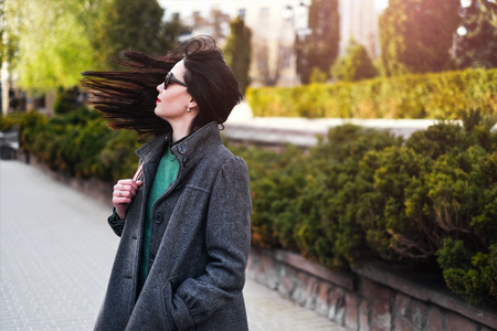 Woman with streaming hair outdoor on the streetの写真素材