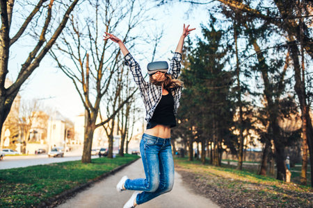 Pretty girl enjoy virtual reality glasses outdoor